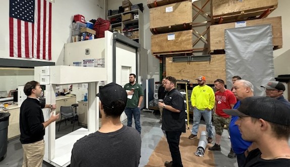  Article content Jimmy Luis, demonstrating the DSI-FW119 Deployable Fabric Fire Wall