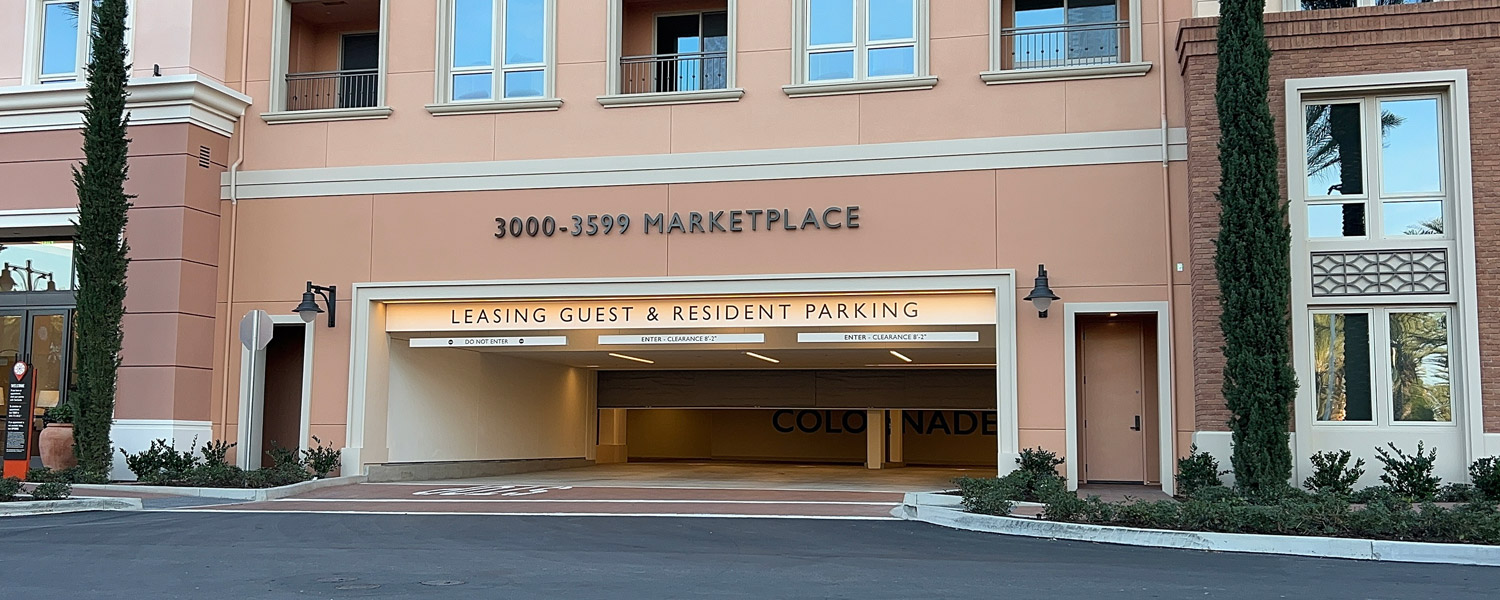 DSI-HS10B-Hose-Stream-Curtain The DSI-HS10B Hose Stream Rated Smoke and Fire Curtain® at an apartment building with an underground parking entrance labeled 'Leasing Guest & Resident Parking' under the sign '3000-3599 Marketplace'.
