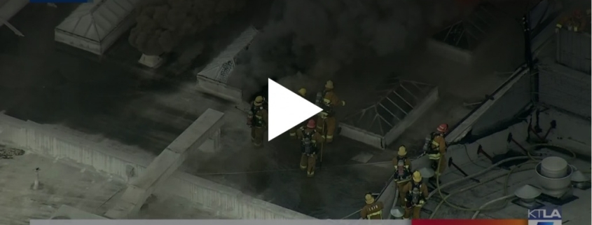 Fire burns through roof of building in Los Angeles